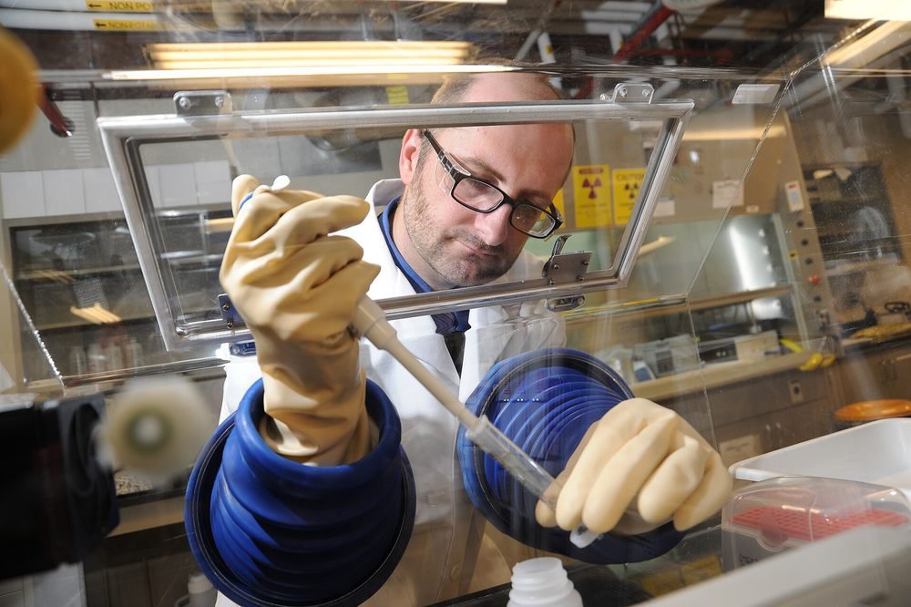 A scientist working at a laboratory bench.